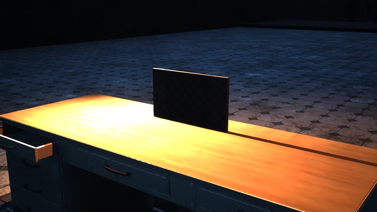 The warden’s desk and computer in the dark office.